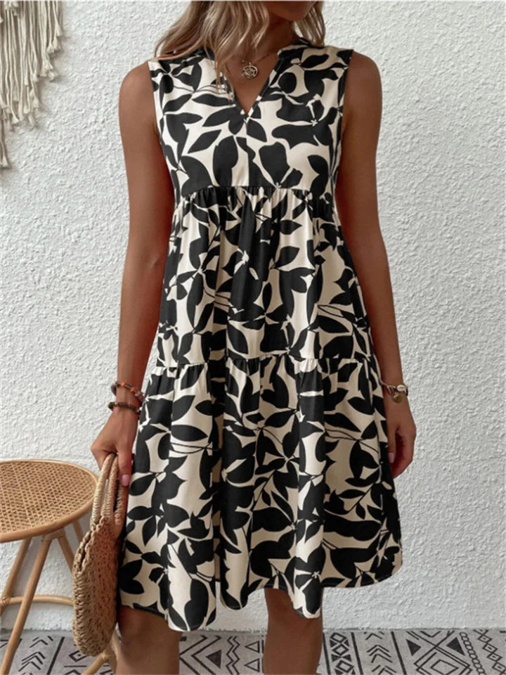 Chic women's A-line midi dress, featuring an elegant floral print and flowy fabric, perfect for summer events.