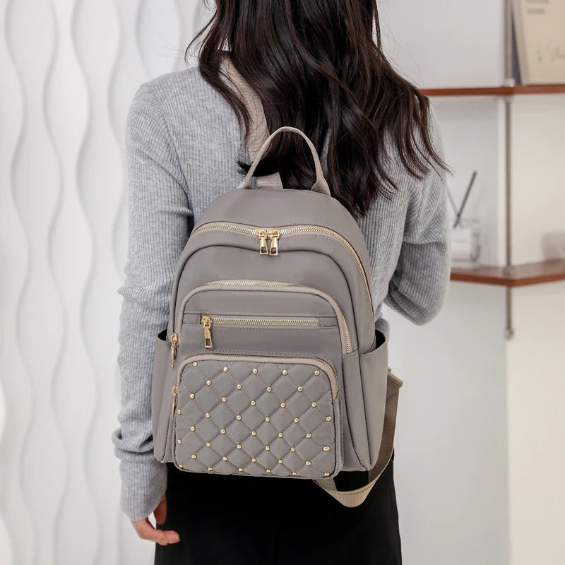 Women's versatile water-resistant nylon backpack, lightweight & stylish for school, travel, and daily adventures.