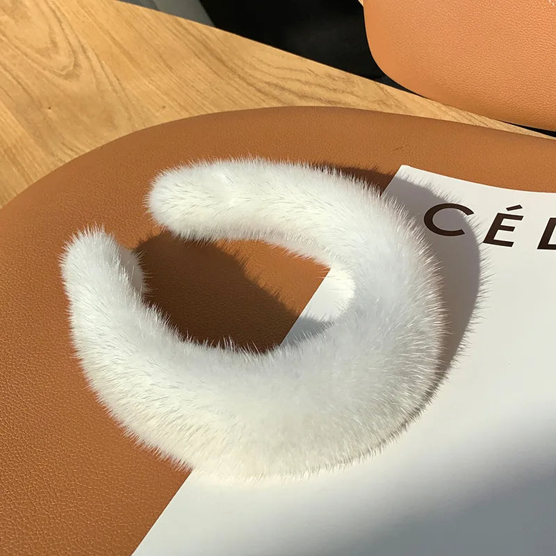 Plush women's faux fur headband, offering luxurious comfort and warmth for winter fashion.