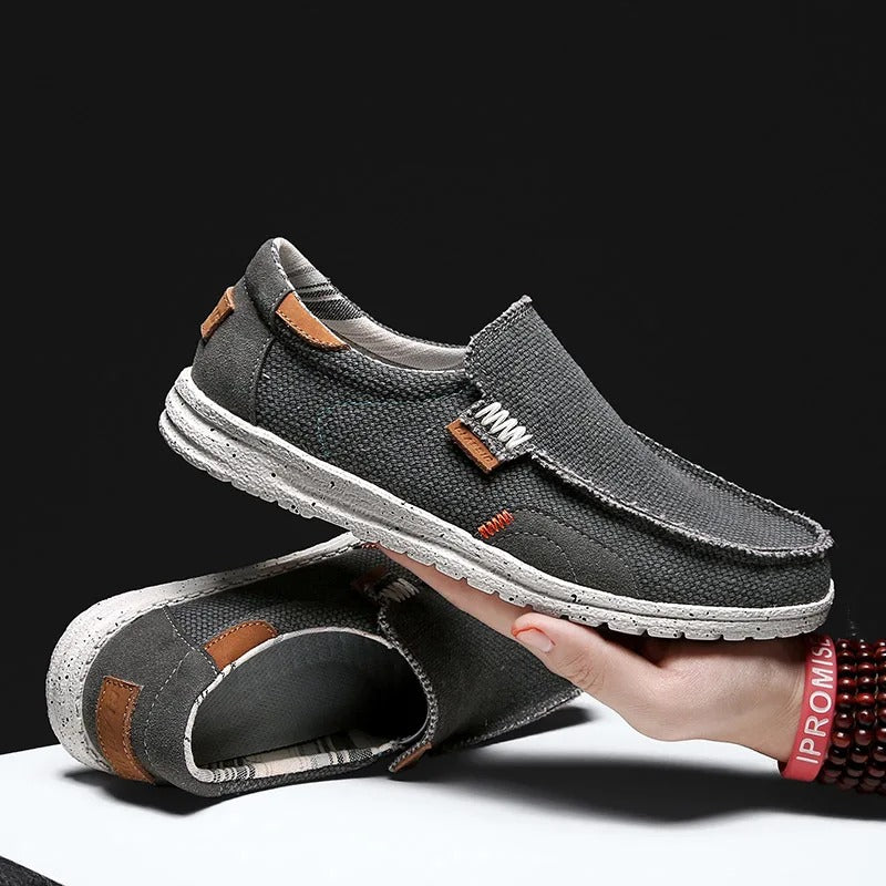 Comfortable blue men's canvas slip-on shoes with a rubber sole, perfect for effortless everyday casual style.