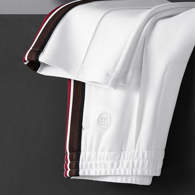 Modern comfort men's pants with spliced design, elastic waist & versatile everyday appeal.