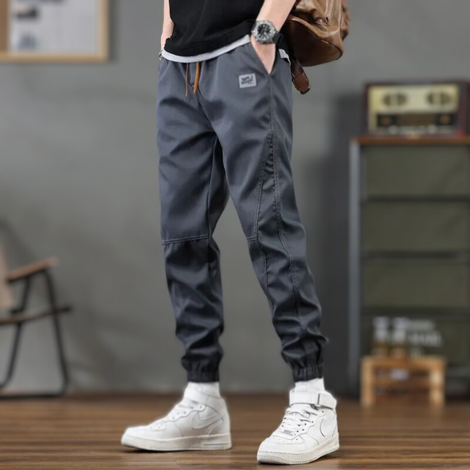 Relaxed fit men's athletic joggers featuring a tapered leg & drawstring, offering ultimate comfort for lounge & sports.
