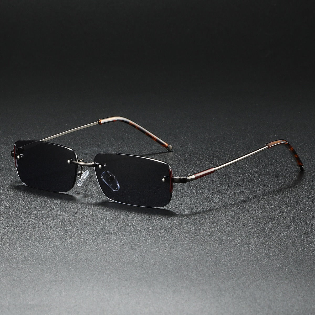 Fashionable rimless rectangular sunglasses with gradient lenses. Lightweight unisex eyewear for sleek style.