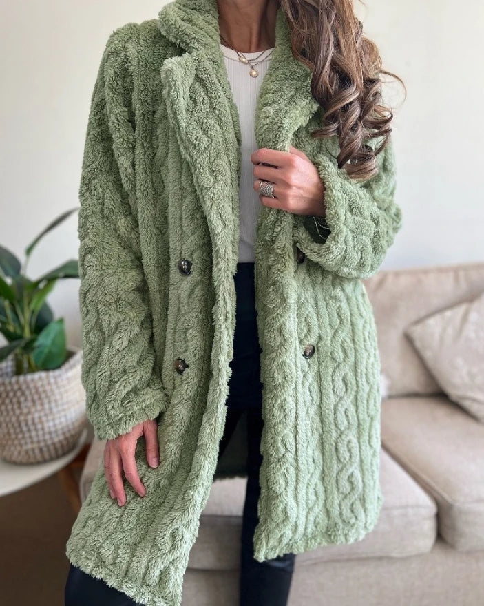 Elegant women's cable knit overcoat, a warm and cozy winter jacket. Stylish long outerwear for chic fashion layering.