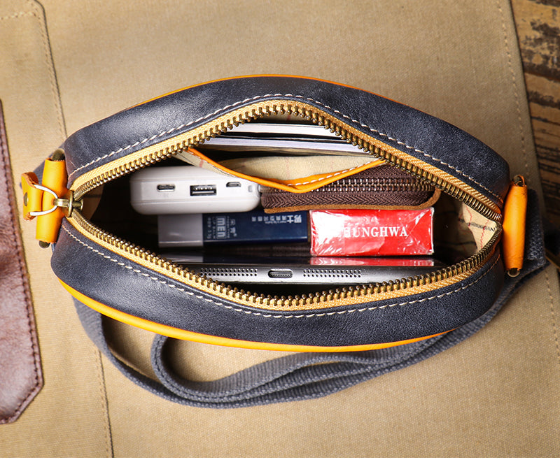 Woman wearing a versatile genuine leather crossbody bag. Adjustable strap allows for comfortable, hands-free styling.