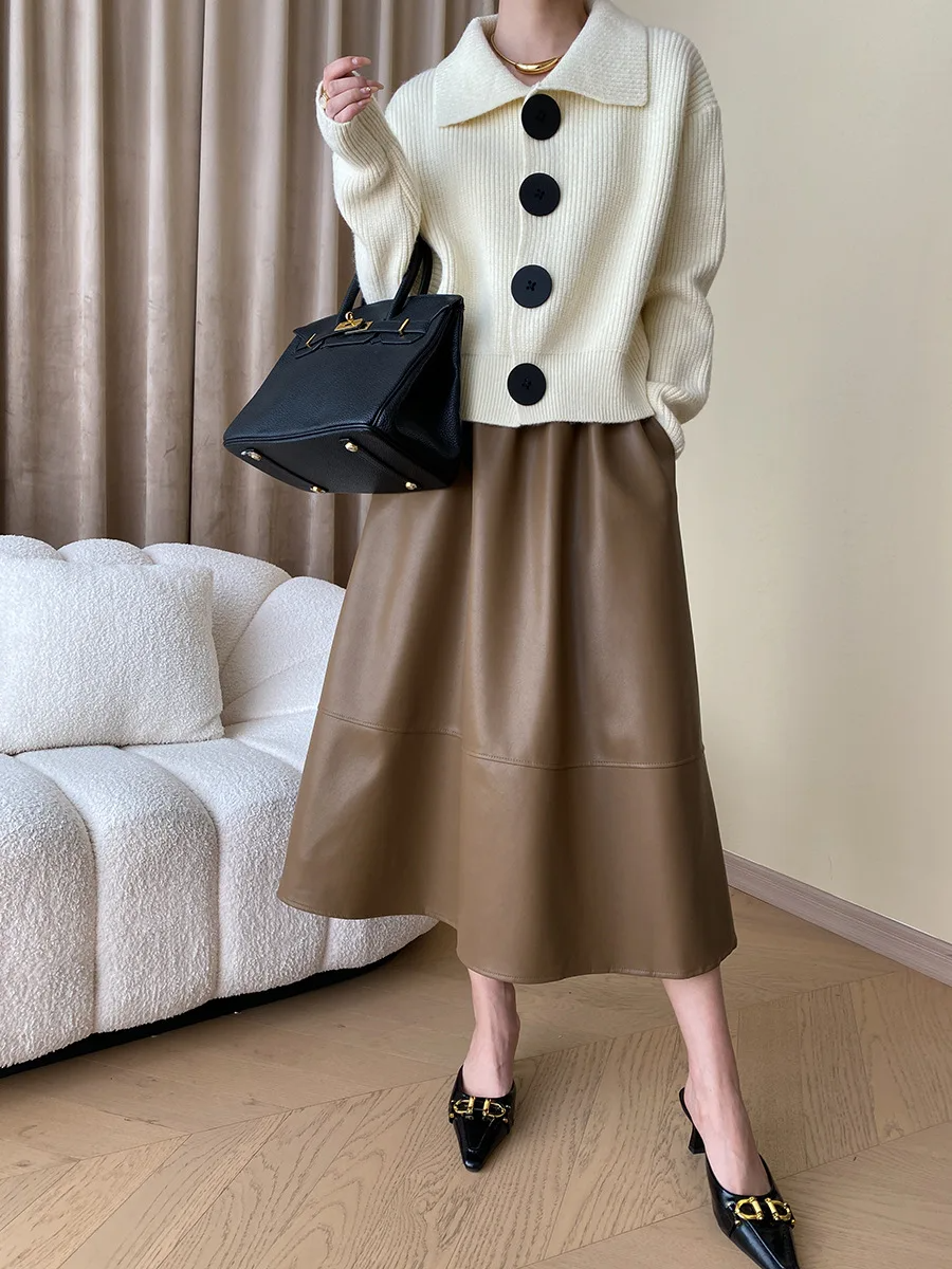 Statement women's sweater with wide collar and button-down front, showcasing effortless style.
