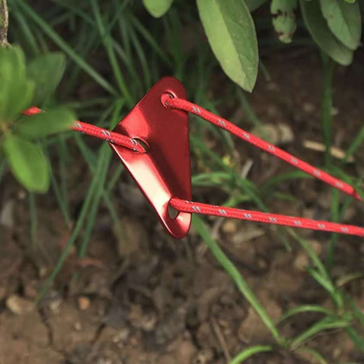 Triangle-shaped red aluminum rope adjusters for camping tents, a lightweight and strong gear accessory