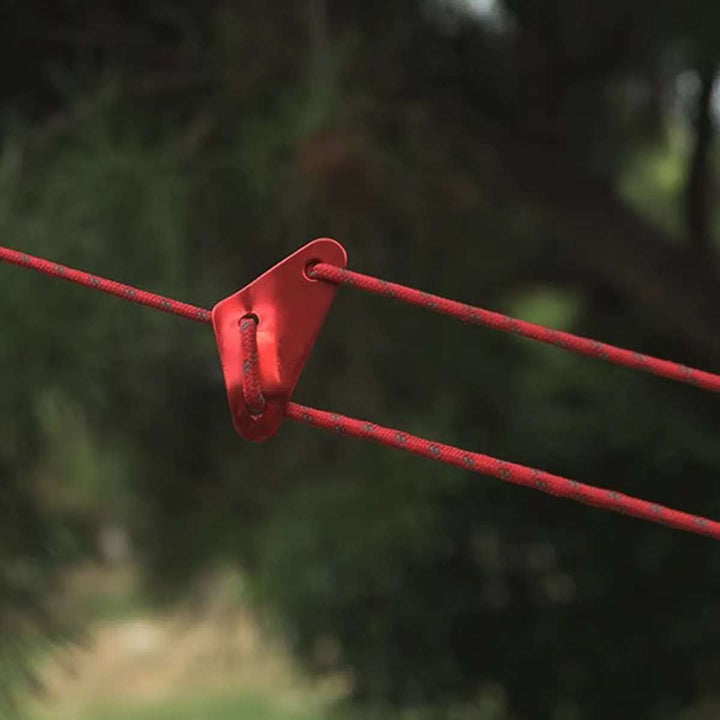 Outdoor camping accessories: a dozen red aluminum rope tensioners for secure and easy rope adjustment