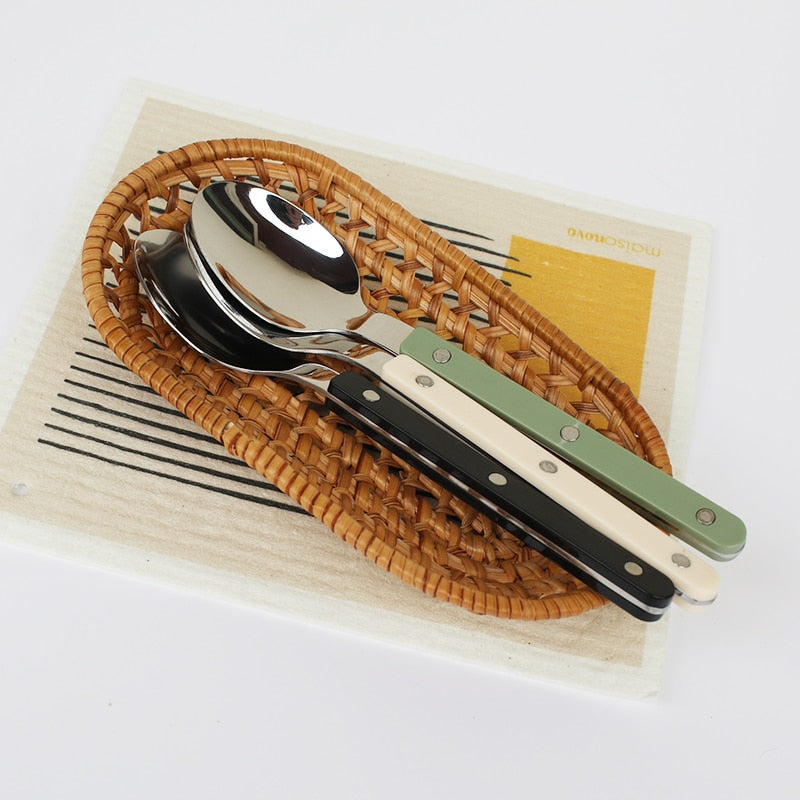 Modern 24-piece stainless steel cutlery set, elegantly engraved for a refined dining experience.