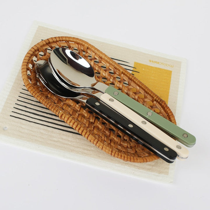 Modern 24-piece stainless steel cutlery set, elegantly engraved for a refined dining experience.