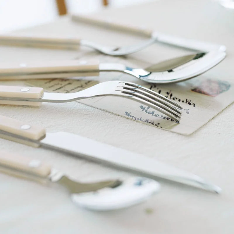 Complete 24-piece stainless steel utensil set with an exquisite engraved design, great for home decor.