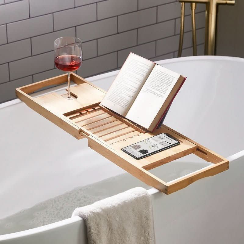Adjustable bamboo bathtub caddy for luxurious spa relaxation. Ideal for holding bath accessories & essentials.