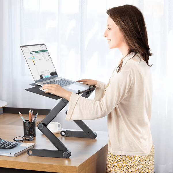 Adjustable ergonomic laptop stand with detachable mouse pad for a comfortable desk workstation setup.