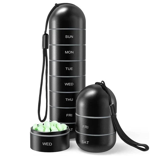 Hand holding a sleek, silver aluminum 7-day pill organizer. Portable medication box.