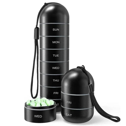 Hand holding a sleek, silver aluminum 7-day pill organizer. Portable medication box.