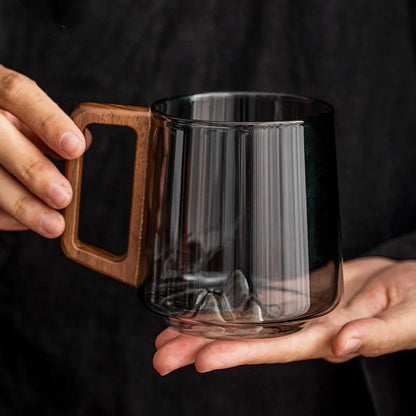 Unique glass mug with stunning 3D mountain base and smooth wooden handle, a perfect artisan gift for coffee lovers.