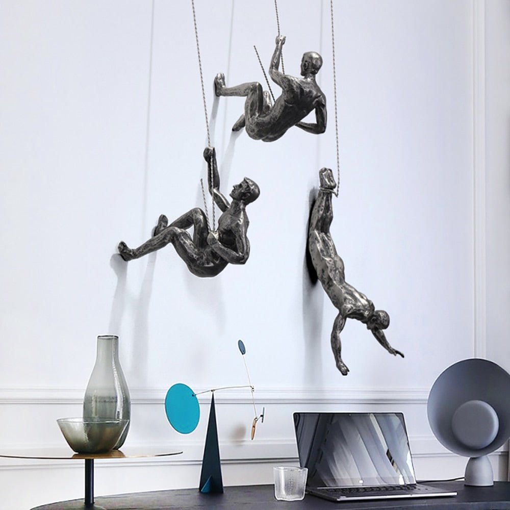 Modern wall decor: Artistic climbing man figure sculpture, a unique home accent.
