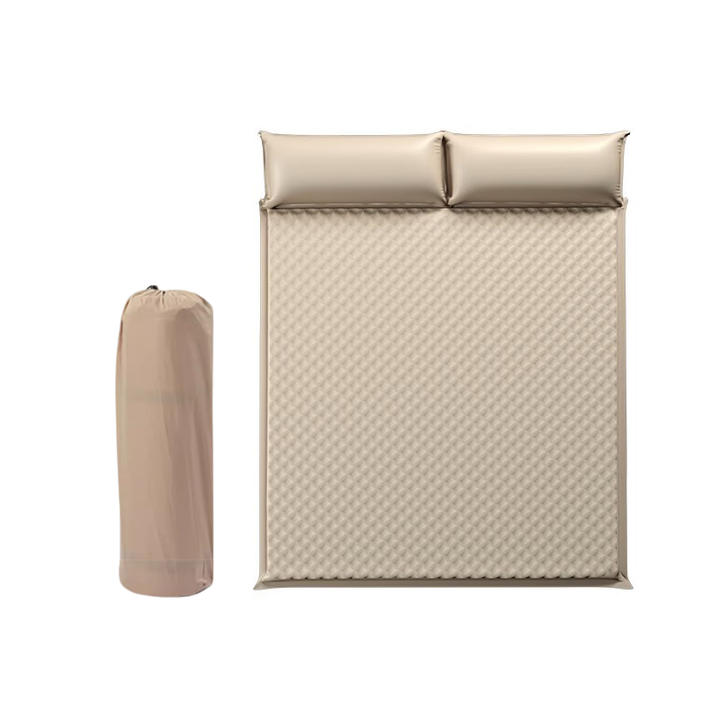 Automatic self-inflating camping mattress next to a campfire, ready for night