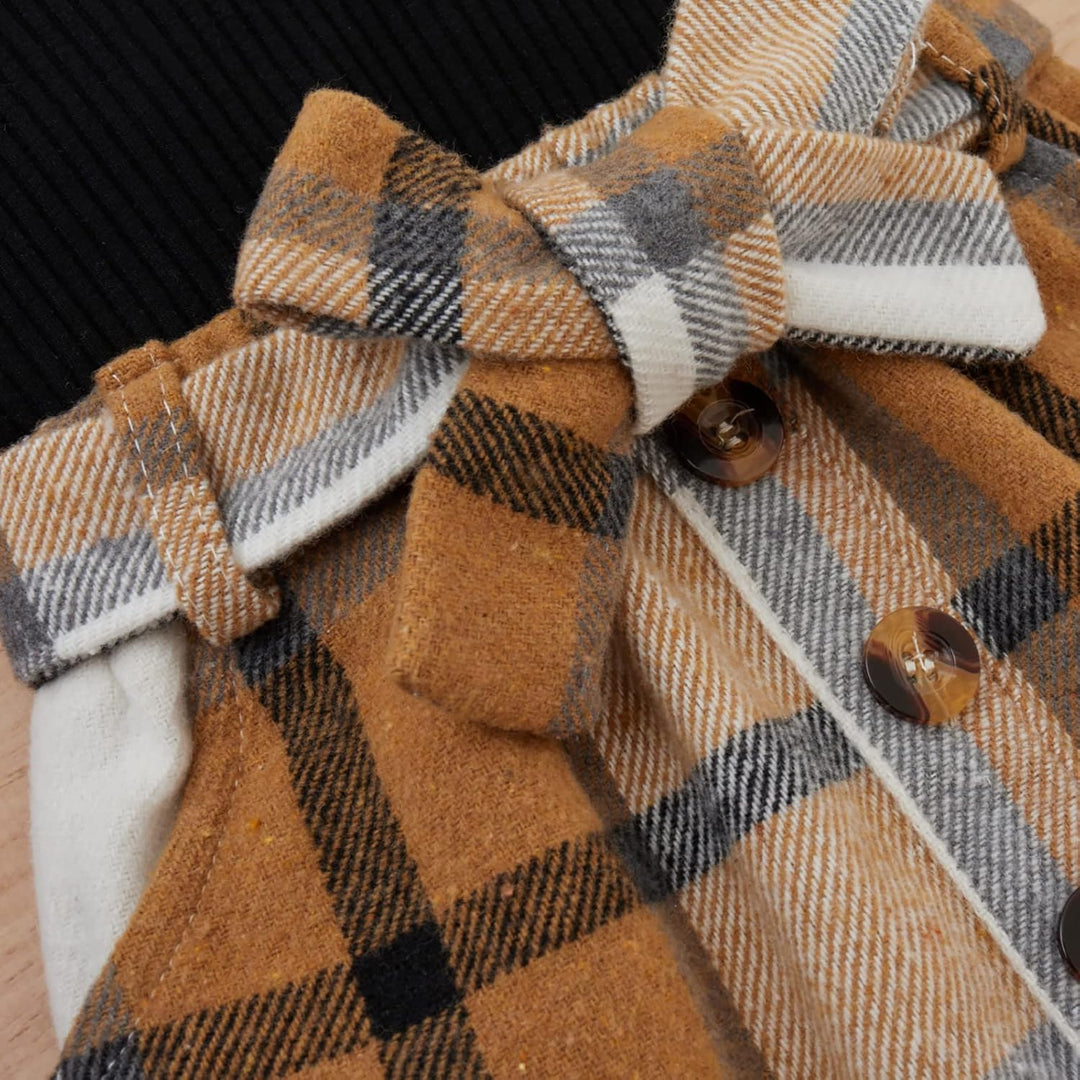 Warm knitted baby girl's winter outfit, turtleneck top and pretty dress.