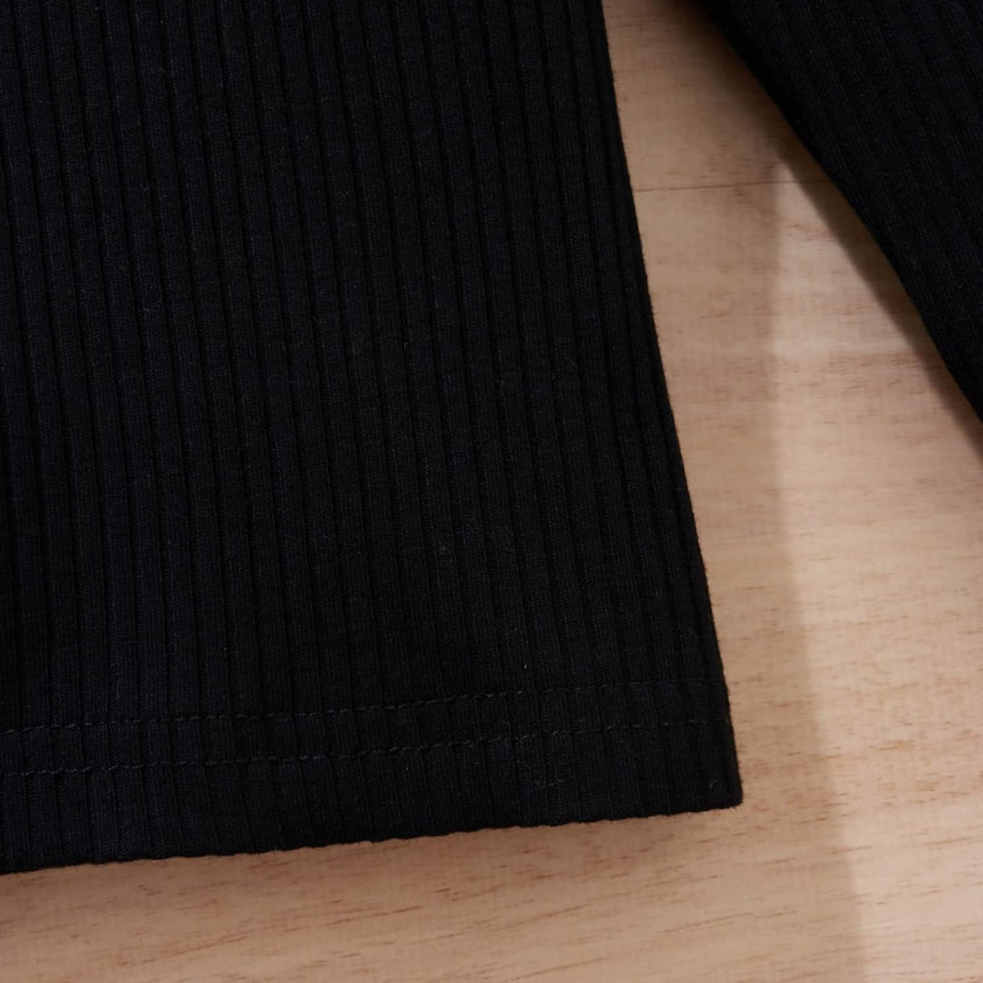 Baby girl's classic knitted turtleneck and dress for a cozy winter look.