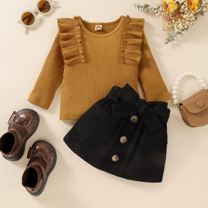 Baby girl's go-to winter wear: soft knit turtleneck and a stylish dress.