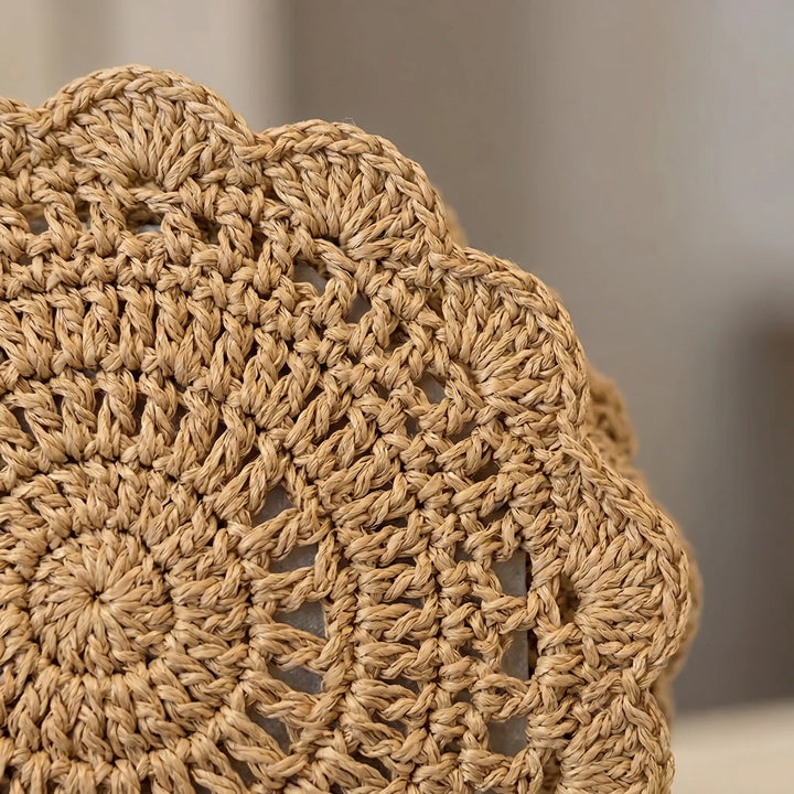 Lightweight women's beige woven crossbody bag. Features a chic scalloped flap & textured design. Casual, summer accessory.