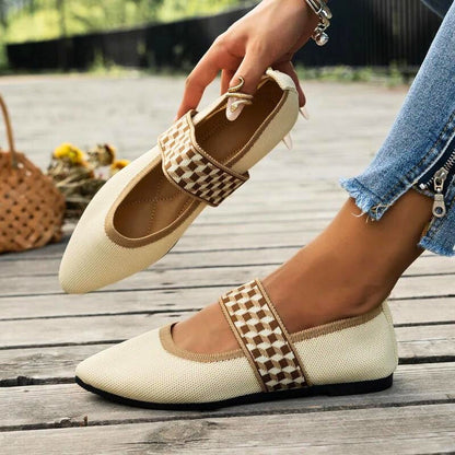 Stylish black slip-on flats for women, offering foot support & casual everyday comfort.