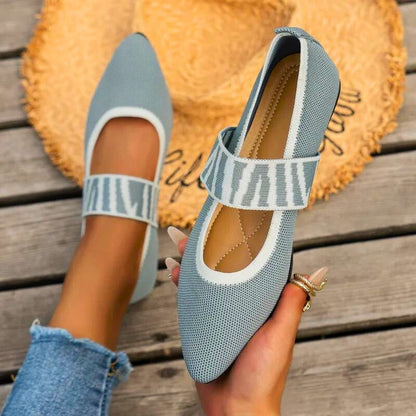 Soft black orthopedic slip-on flats for women, providing stylish comfort & reliable arch support.