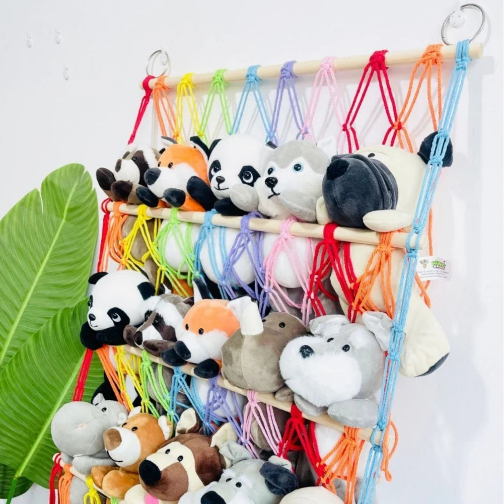 Clutter-free kids' room with a berry blue toy storage hammock. Perfect wall net for children's stuffed animal organization.