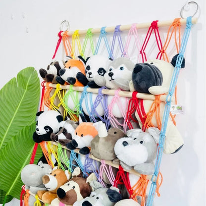 Clutter-free kids' room with a berry blue toy storage hammock. Perfect wall net for children's stuffed animal organization.
