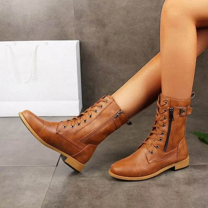 Brown comfortable mid-calf buckle boots for women, offering edgy style & durable footwear.
