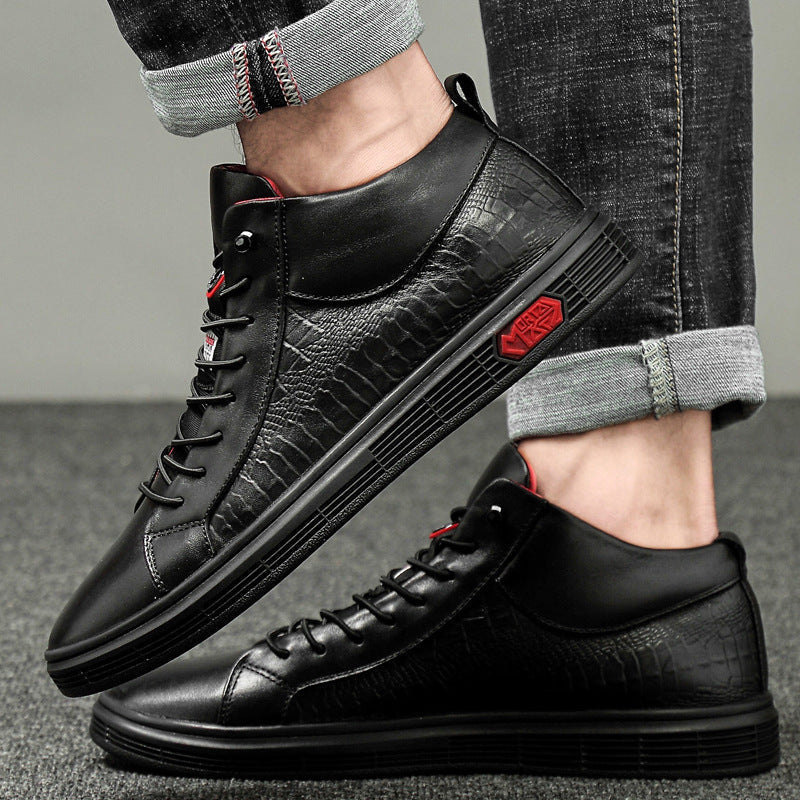 Close-up of men's black high-top fashion sneakers, showcasing red accents & stylish details.