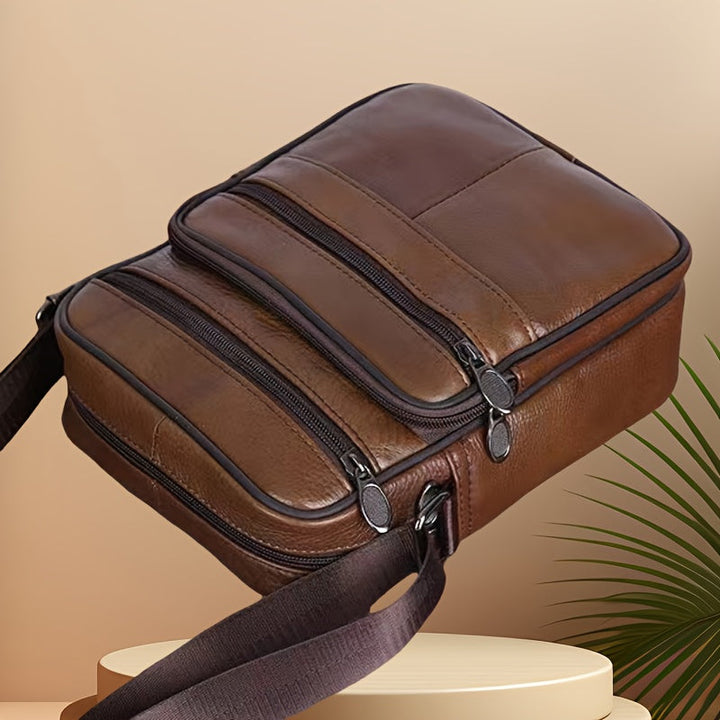 Men's black cross-body bag. Ideal for work, travel & everyday essentials. Spacious with adjustable strap.