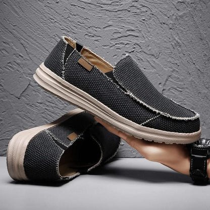 Classic men's black slip-on loafers, offering versatile casual style & lightweight comfort footwear.
