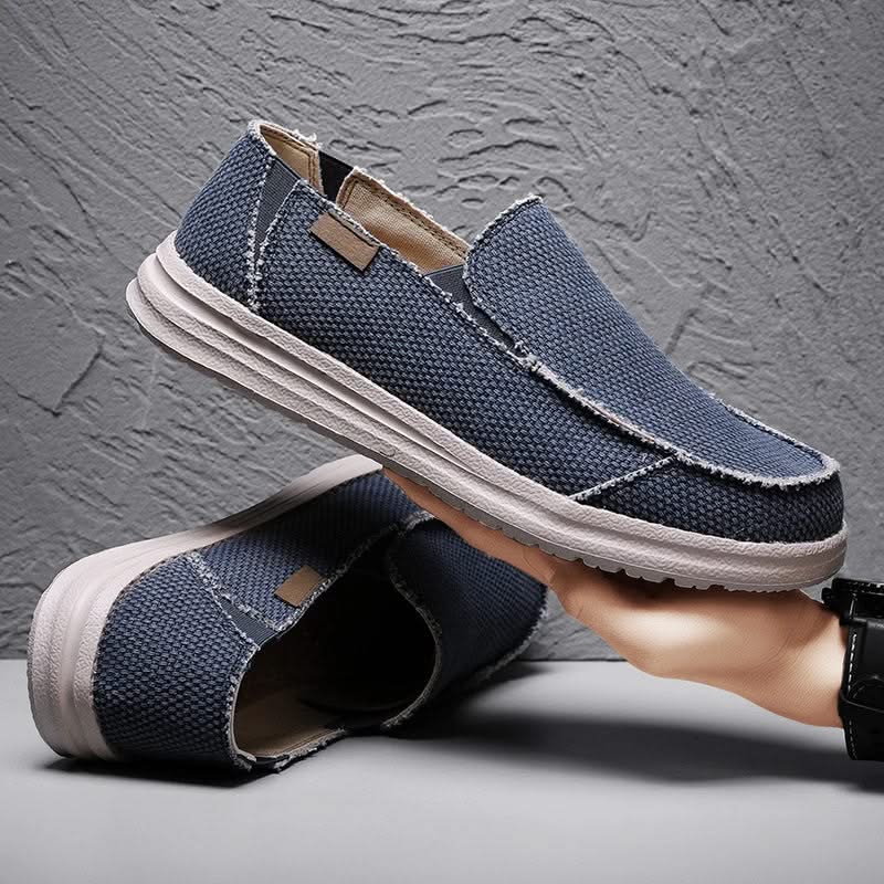 Man wearing blue lightweight slip-on loafers, walking comfortably. Versatile casual men's everyday footwear.