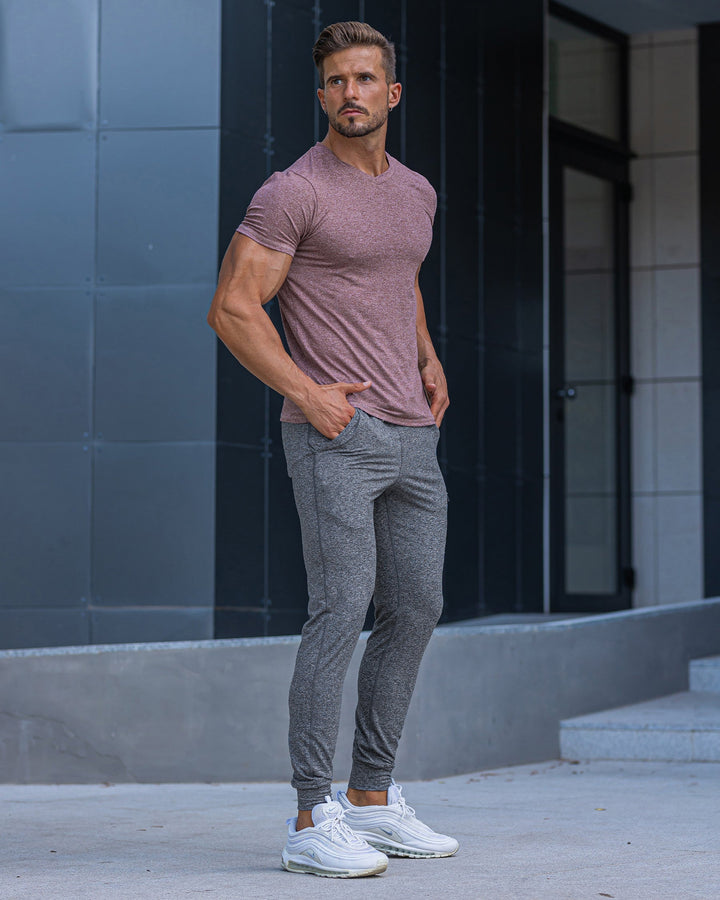 Olive men's stretch pants, casual comfort, paired with a hoodie, relaxed look.
