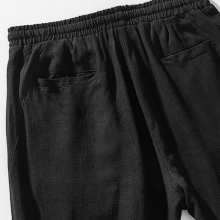 Men's black casual pants, relaxed fit, with drawstring for comfortable and effortless everyday style.