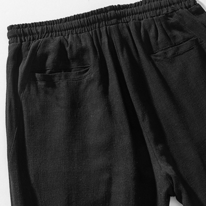 Men's black casual pants, relaxed fit, with drawstring for comfortable and effortless everyday style.