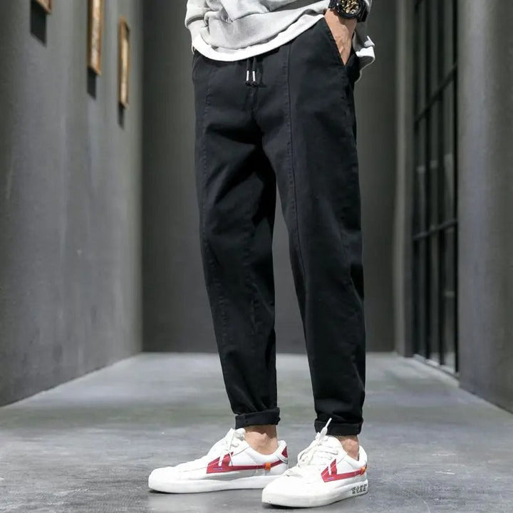 Essential men's fashion: tapered joggers in black, designed for ultimate comfort and contemporary style.