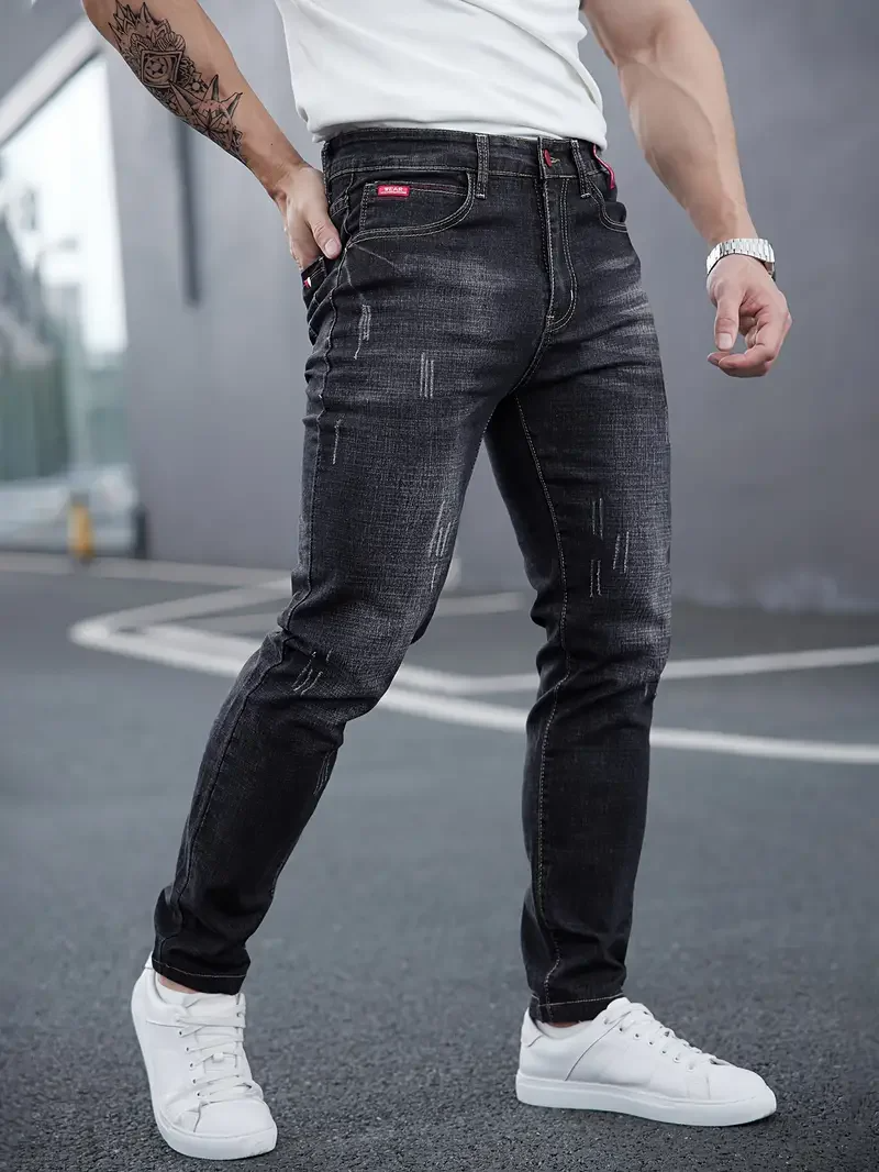Black men's tapered slim-fit jeans, distressed for a modern streetwear look.