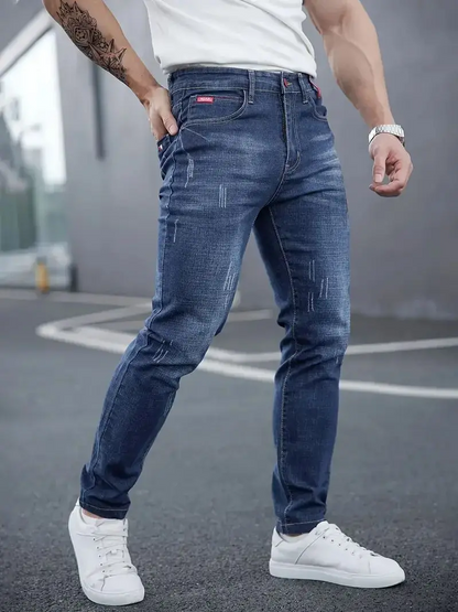 Men's Savage Cut tapered jeans, slim-fit blue denim, ideal for modern streetwear style.