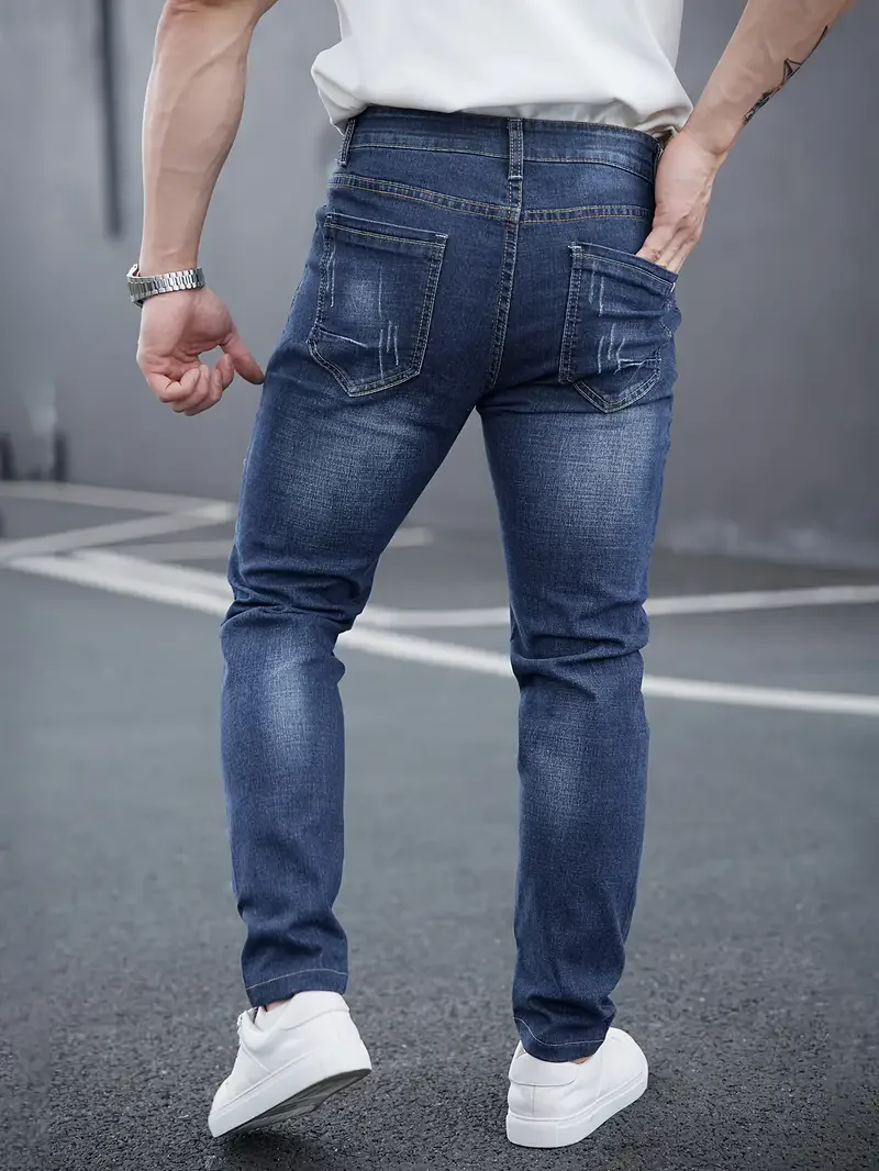 Versatile black tapered jeans for men, featuring a modern slim fit & distressed details.