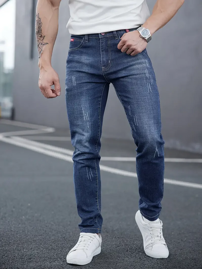 Modern slim-fit men's tapered jeans in distressed black, perfect for streetwear fashion.