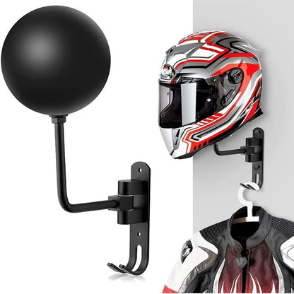 Black metal motorcycle helmet wall mount with integrated jacket hooks for gear storage.