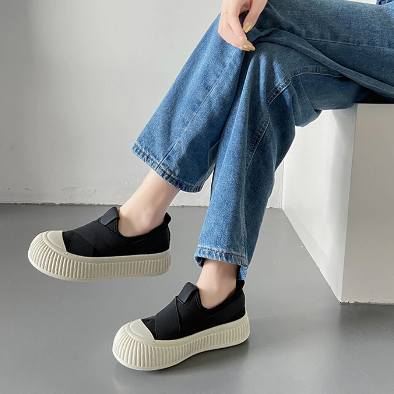 White Seraphine platform loafers for women. Elegant, comfortable slip-on footwear, perfect for a modern casual outfit.
