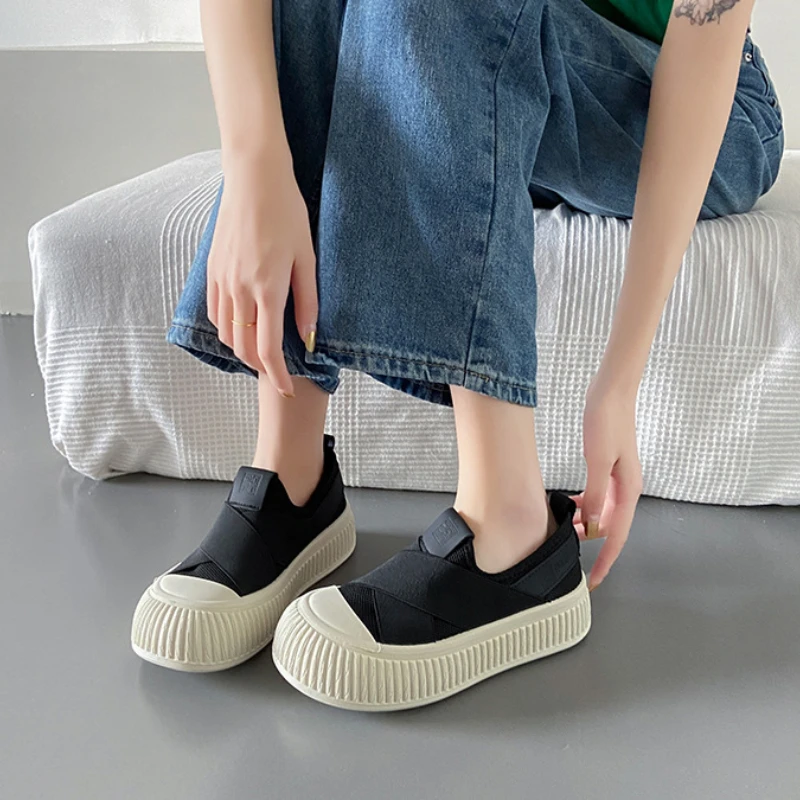 Side view of women's black Seraphine platform loafers. Showcases the modern platform sole & comfortable slip-on design.