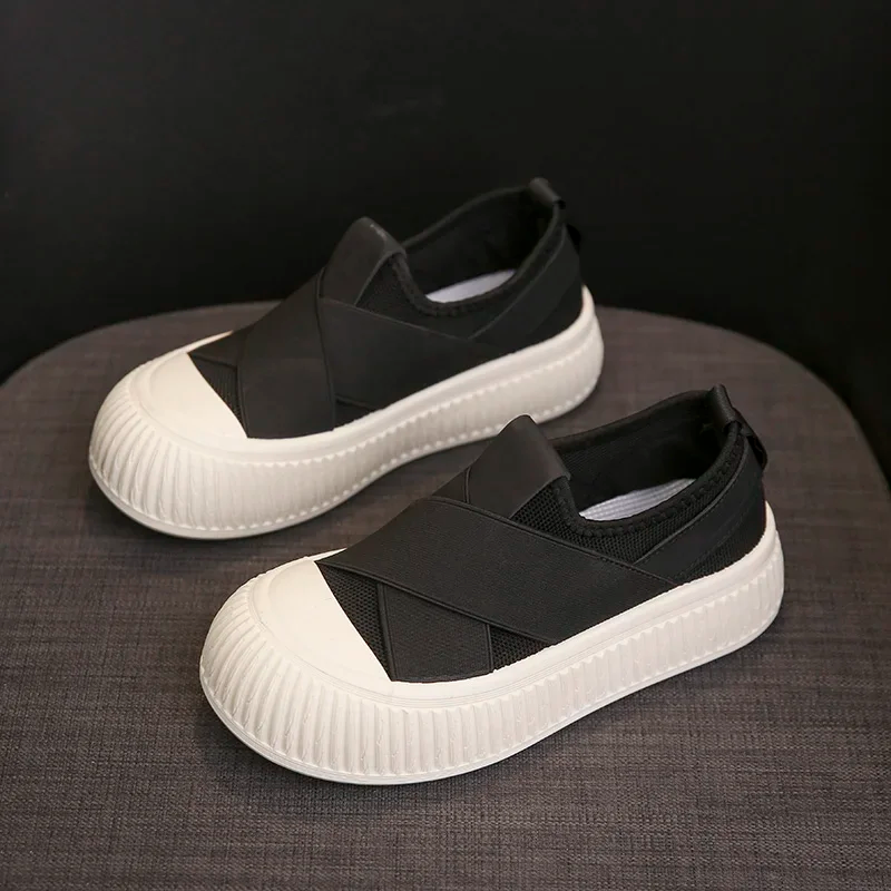 Woman wearing black Seraphine platform loafers. Comfortable, trendy slip-on shoes for a modern casual outfit.