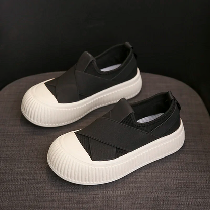 Woman wearing black Seraphine platform loafers. Comfortable, trendy slip-on shoes for a modern casual outfit.