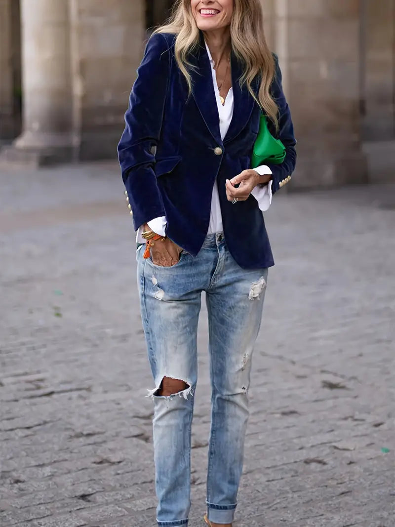 Elegant blue women's blazer, slim fit, with prominent gold button cuffs & a sleek peak lapel. Formal or casual.