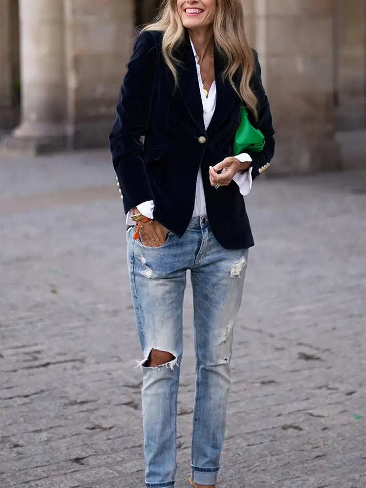 Stylish black women's blazer, slim fit, with gold button details on cuffs and a refined peak lapel.
